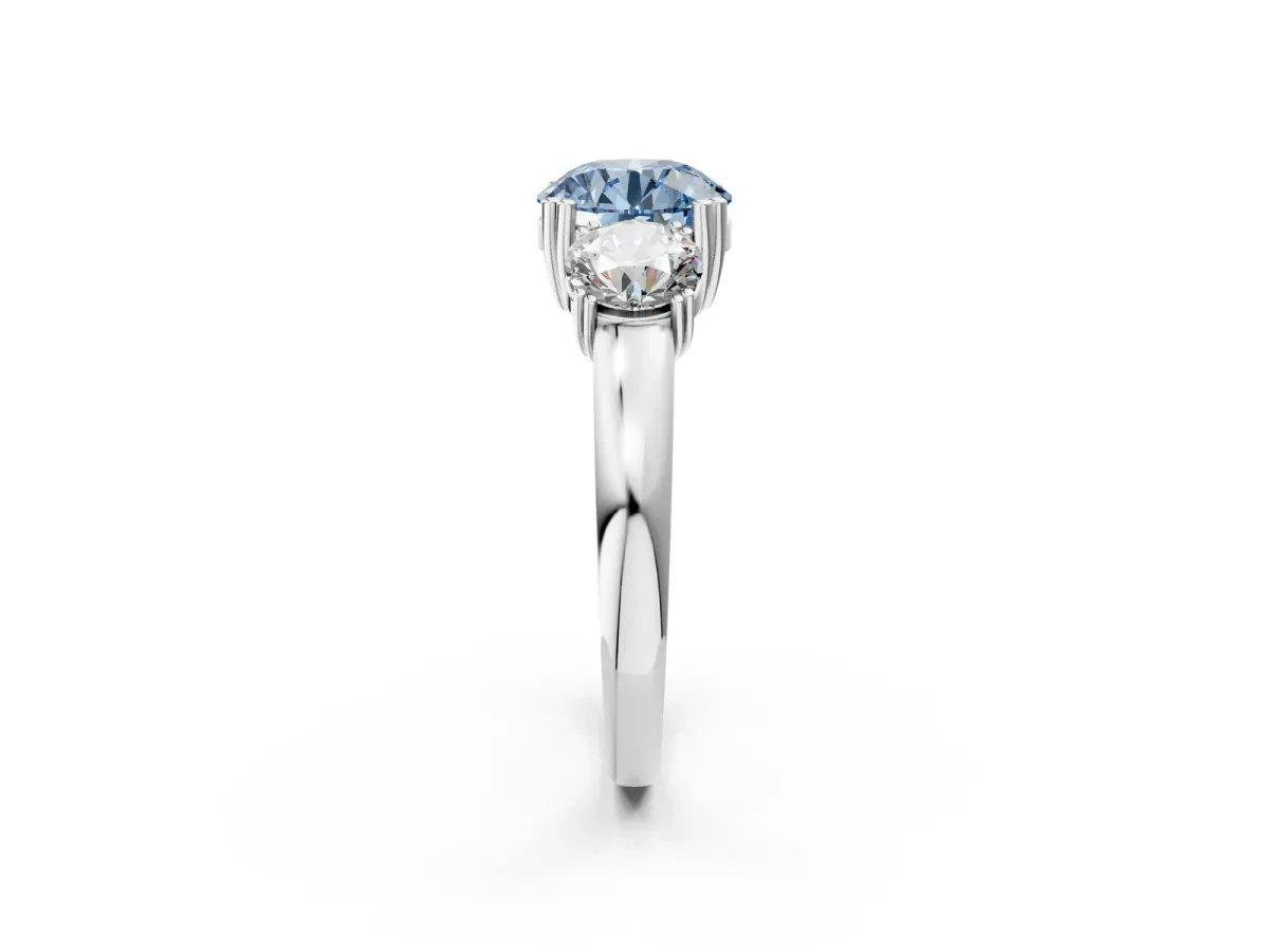Fancy Blue Three-Stone Round Cut Cut Diamond Ring with Channel Set Band and Four-Prong Setting Platinum