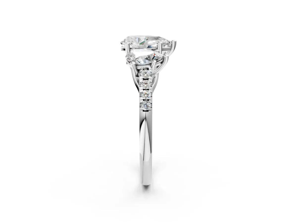 Three-Stone Pear Cut Diamond Ring with Round Pavé Band and Prong Setting Platinum
