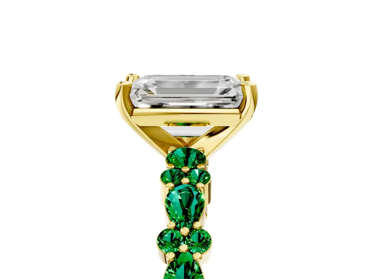 Emerald Cut Diamond Side Stone Solitaire Ring with Round Emerald and Four-Prong Setting Yellow gold