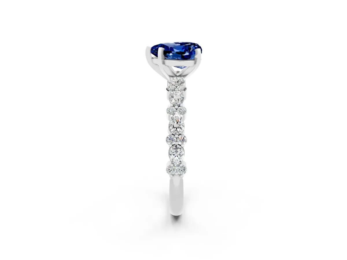Heart Cut Blue Sapphire Side Stone Solitaire Ring with Round and Four-Prong Setting Platinum