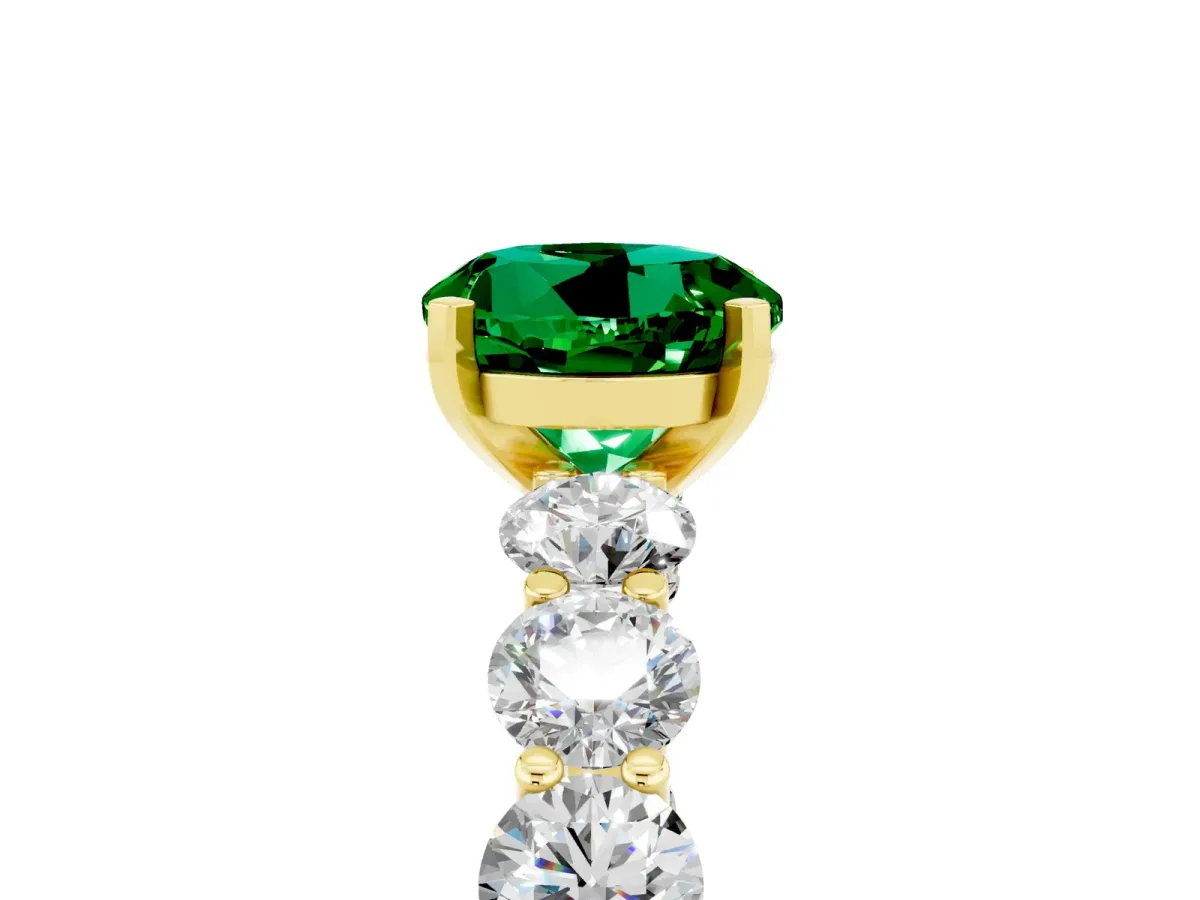 Round Cut Emerald Prong Setting with Side Stones on a Pave Band Yellow gold