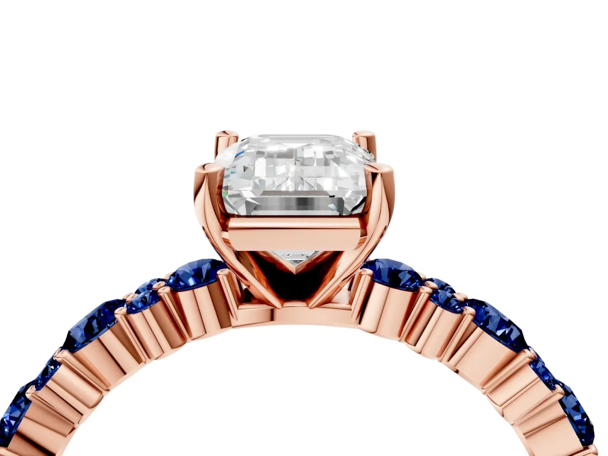 Emerald Cut Diamond Side Stone Solitaire Ring with Round Blue Sapphire and Four-Prong Setting Rose gold
