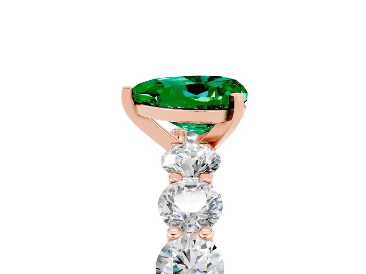 Heart Cut Emerald Prong Setting with Side Stones on a Pave Band Rose gold