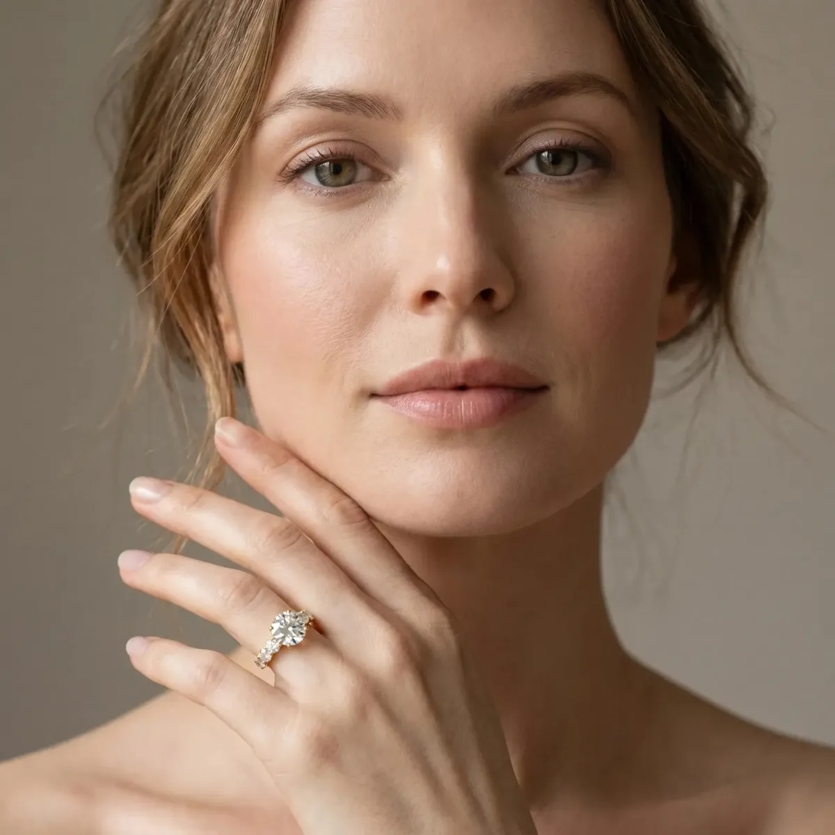 Round Cut Diamond Prong Setting with Side Stones on a Pave Band Yellow gold