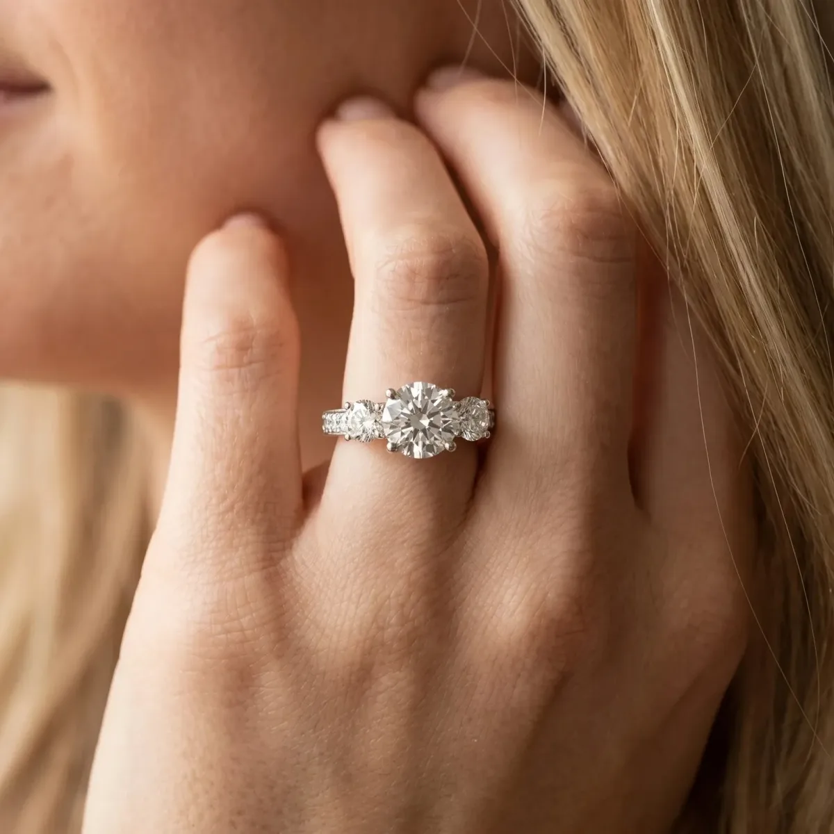 Three-Stone Round Cut Cut Diamond Engagement Ring with Split Shank and Prong Setting Platinum
