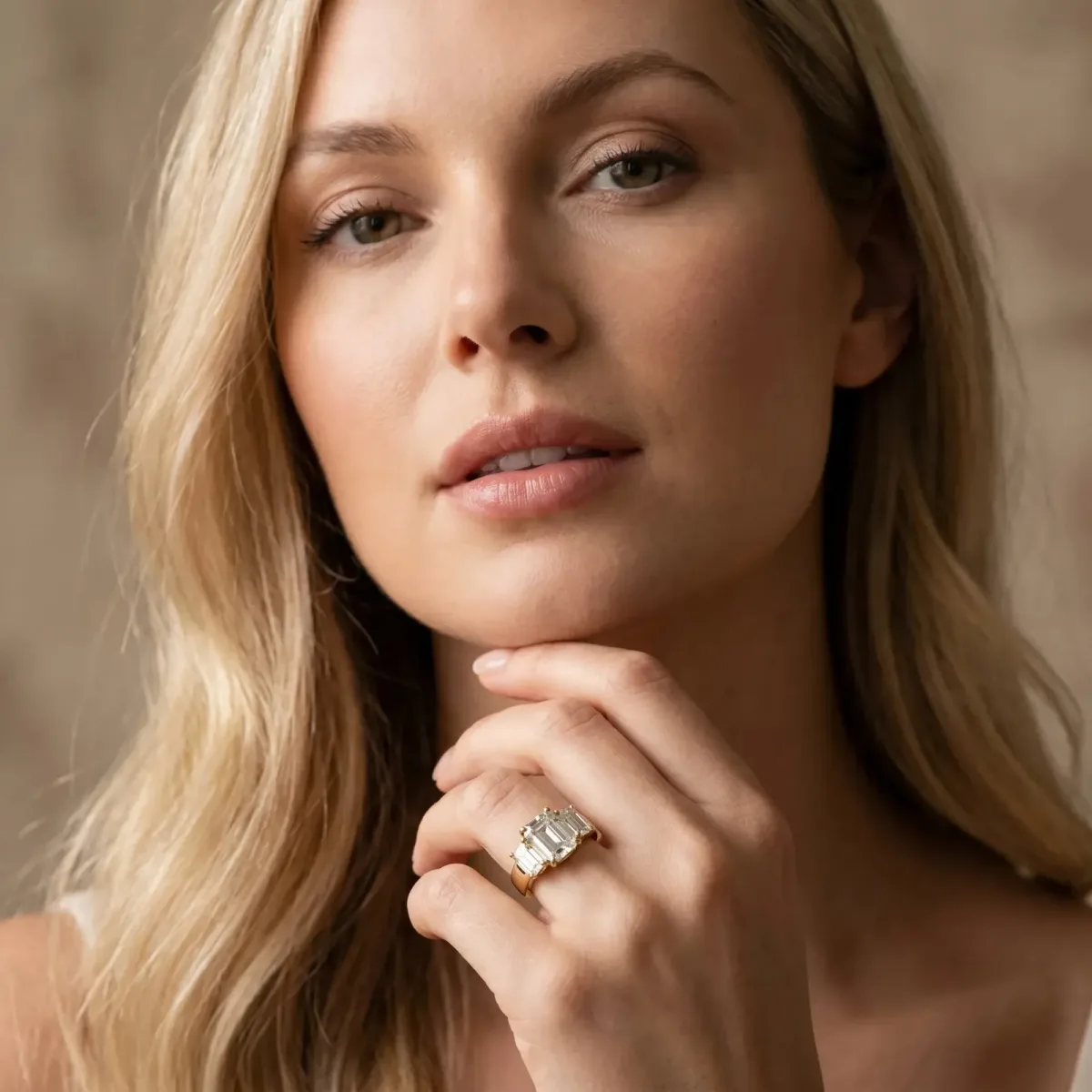 Three-Stone Emerald Cut Cut Diamond Ring with Channel Set Band and Four-Prong Setting Yellow gold