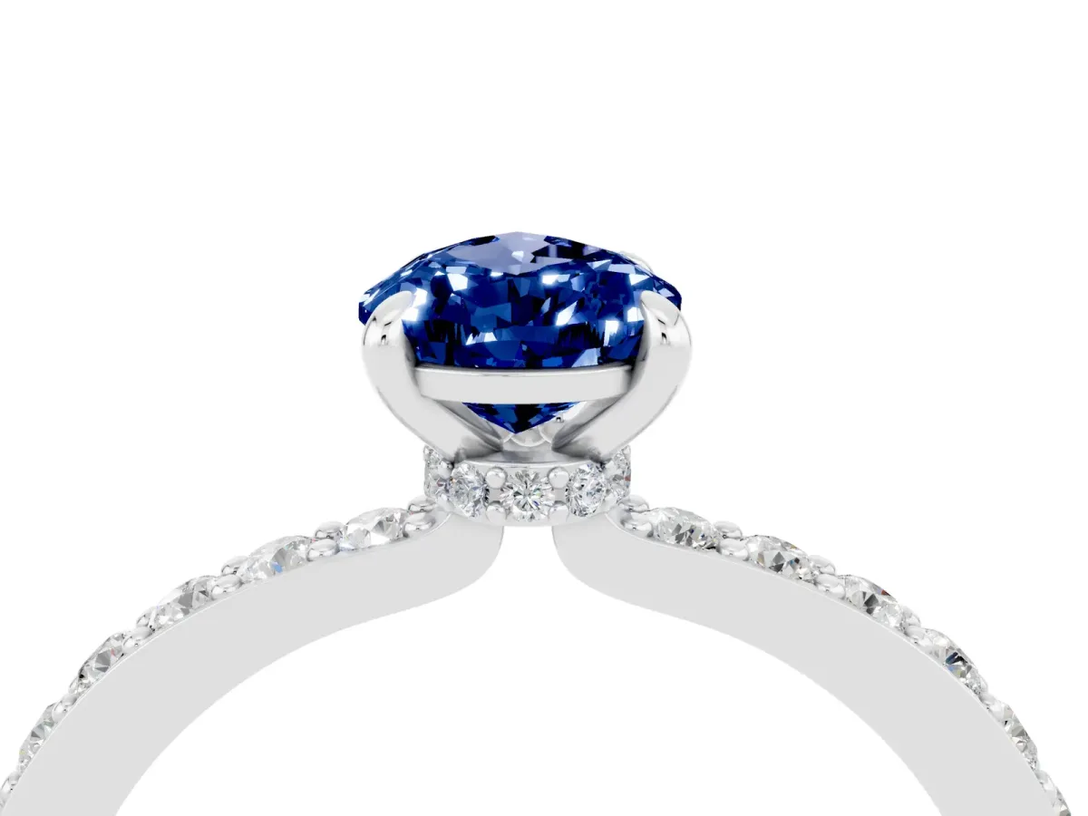 Pear Cut Blue Sapphire Solitaire Engagement Ring with Pavé Band and Four-Prong Setting Silver