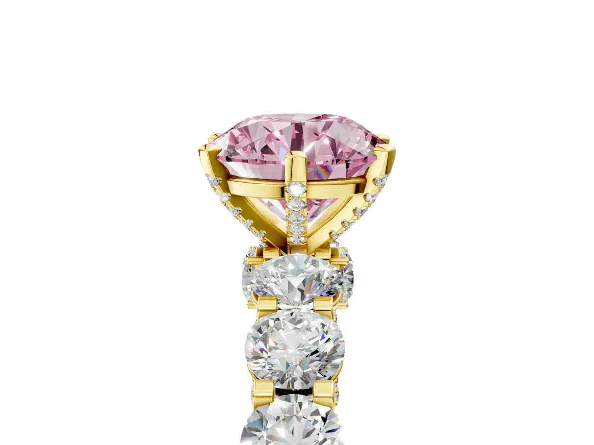 Fancy Pink Round Cut Diamond Side Stone Engagement Ring with Four-Prong Setting Yellow gold