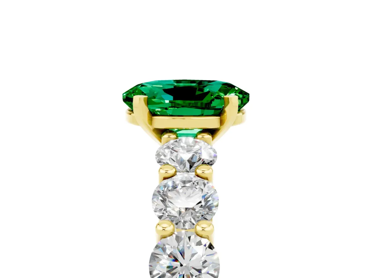 Oval Cut Emerald Prong Setting with Side Stones on a Pave Band Yellow gold