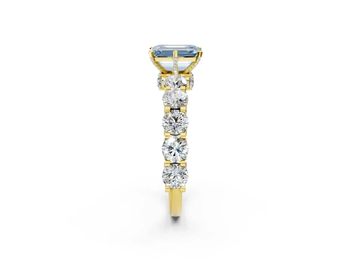 Fancy Blue Emerald Cut Diamond Side Stone Engagement Ring with Four-Prong Setting Yellow gold