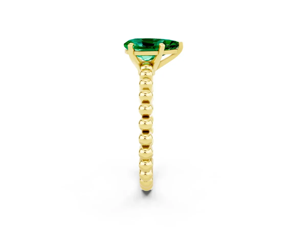 Pear Cut Emerald Solitaire Ring with Beaded Band and Prong Setting Yellow gold