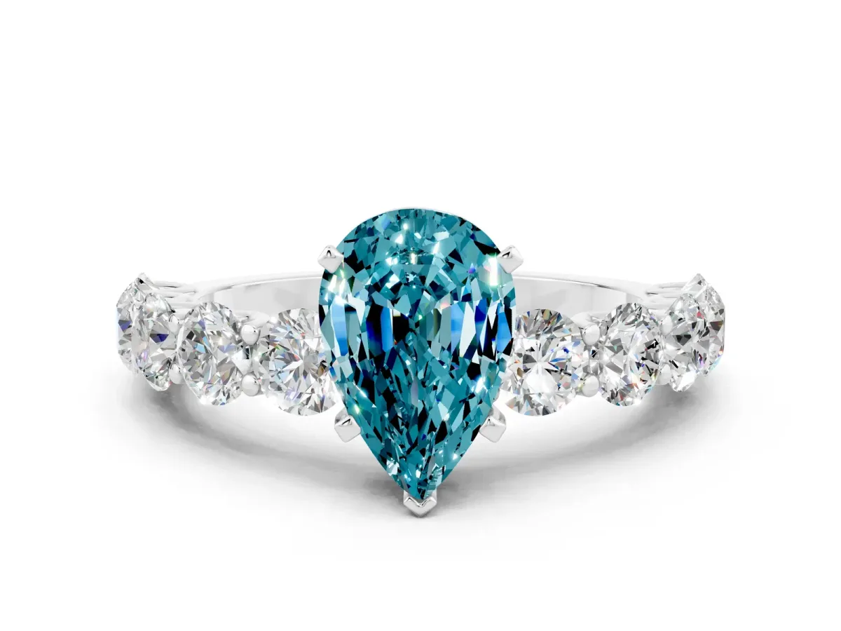 Pear Cut Blue Topaz Prong Setting with Side Stones on a Pave Band Silver