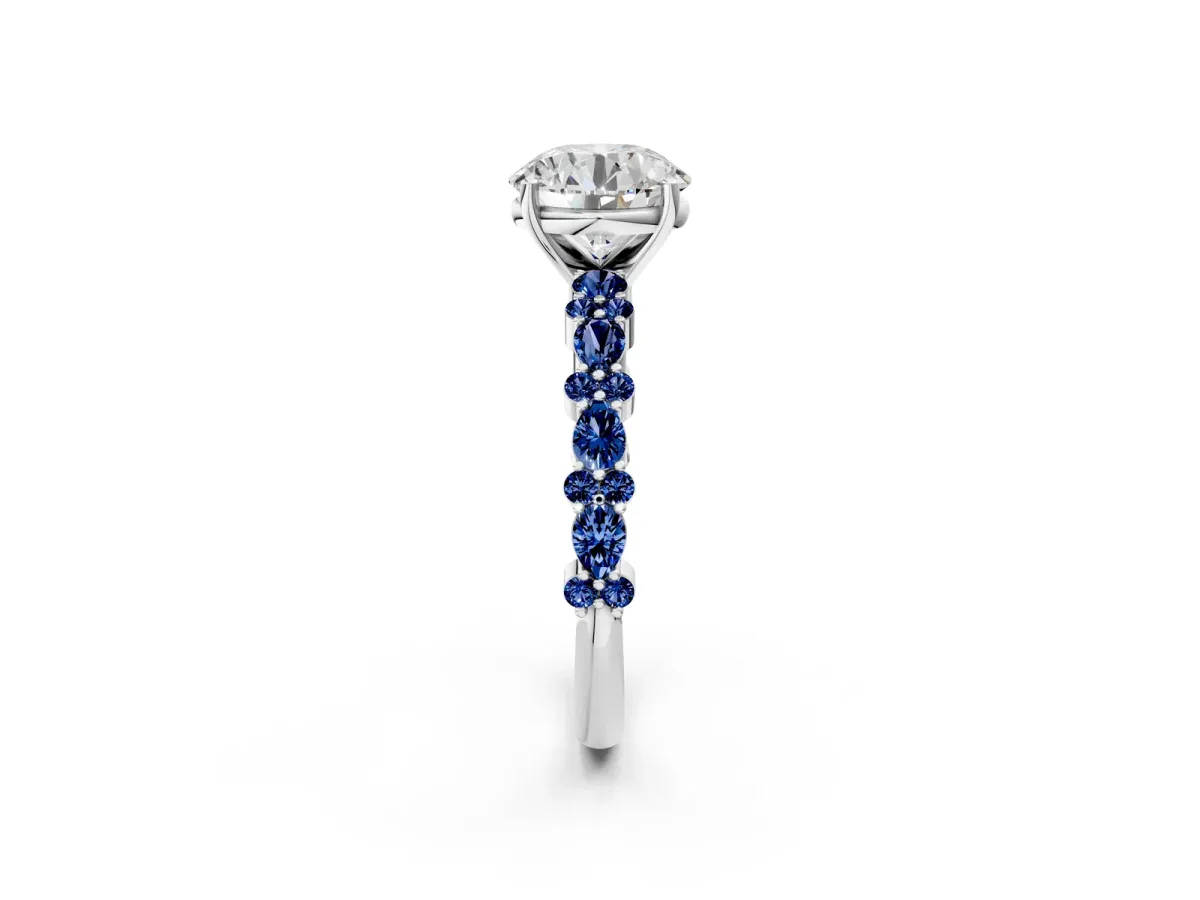 Round Cut Diamond Side Stone Solitaire Ring with Round Blue Sapphire and Four-Prong Setting Silver