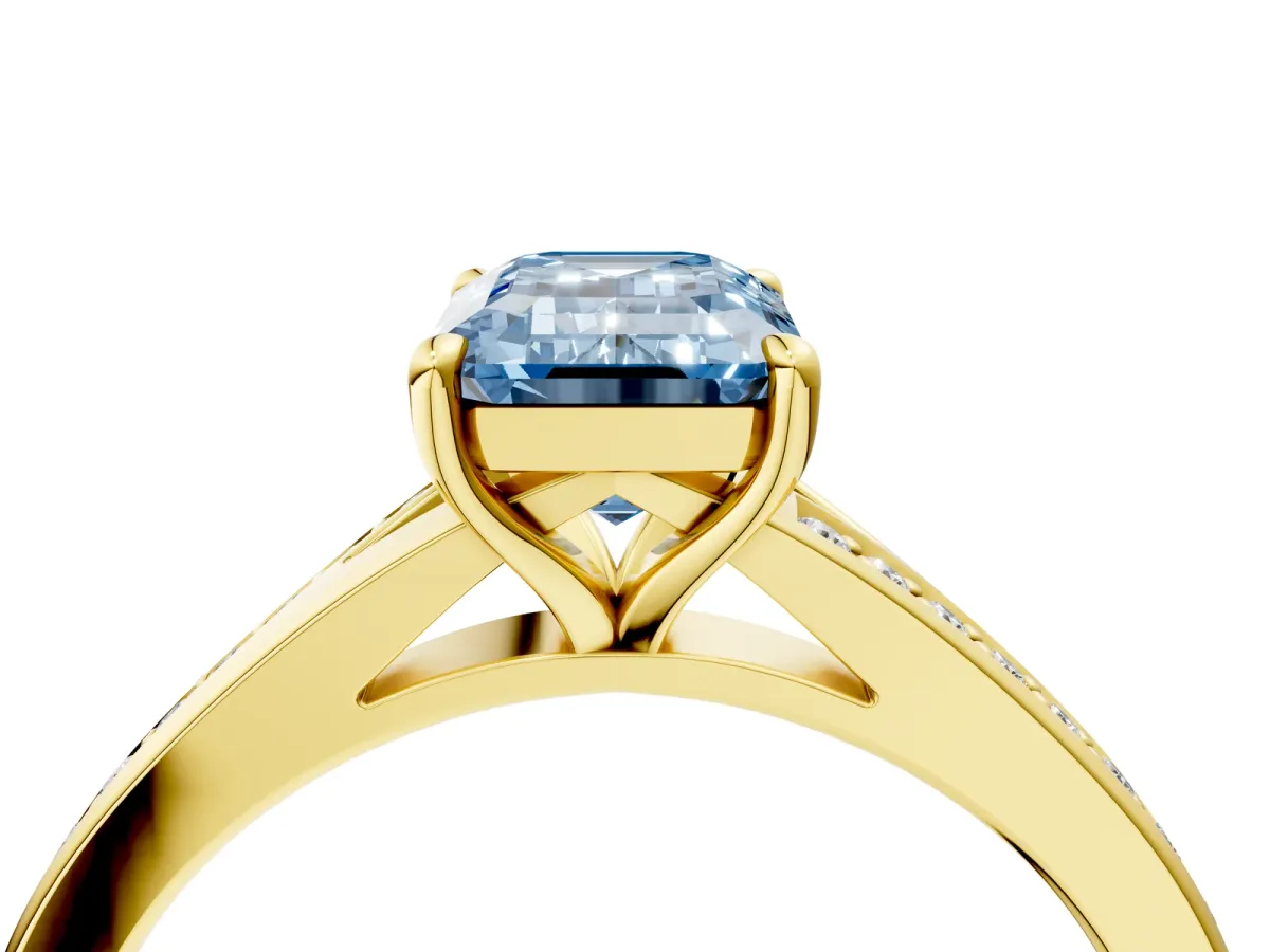 Fancy Blue Emerald Cut Diamond Solitaire Ring with Pavé Band and Prong Setting Yellow gold