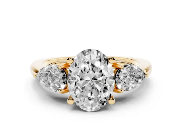 Oval Cut Cut Three-Stone Diamond Ring with Pear Side Stones on a Classic Solitaire Band with Prong Setting Yellow gold