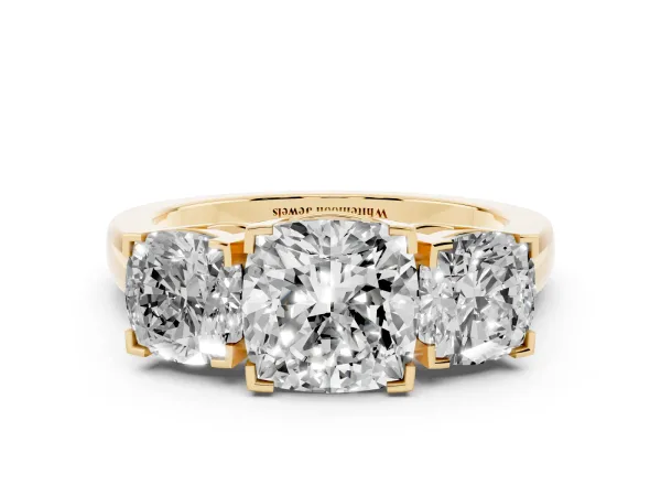 Three-Stone Cushion Cut Cut Diamond Ring with Channel Set Band and Four-Prong Setting Yellow gold