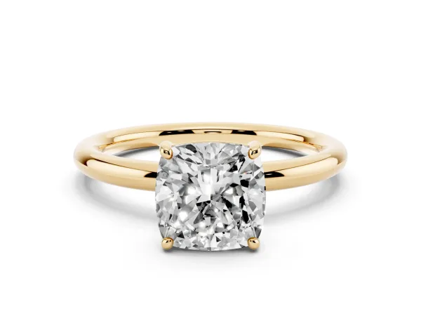 Cushion Cut Solitaire Diamond Ring with Four-Prong Setting on a Plain Band Yellow gold