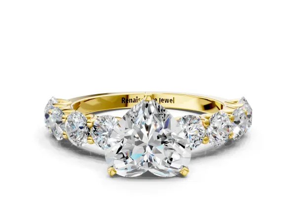 Heart Cut Diamond Prong Setting with Side Stones on a Pave Band Yellow gold