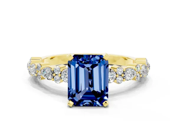 Emerald Cut Blue Sapphire Side Stone Solitaire Ring with Round and Four-Prong Setting Yellow gold