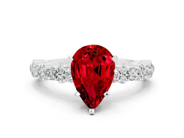 Pear Cut Ruby Side Stone Solitaire Ring with Round and Four-Prong Setting White gold