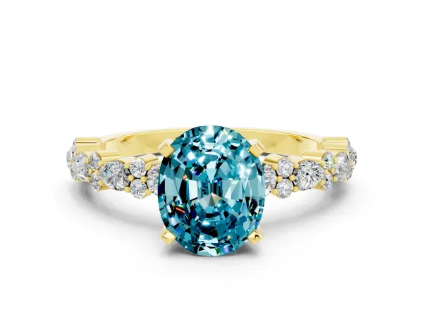 Oval Cut Blue Topaz Side Stone Solitaire Ring with Round and Four-Prong Setting Yellow gold