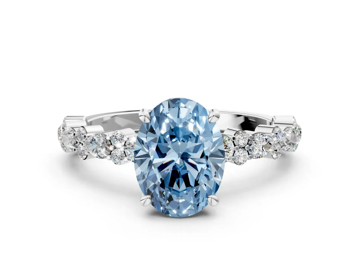 Fancy Blue Oval Cut Diamond Side Stone Solitaire Ring with Round and Four-Prong Setting White gold