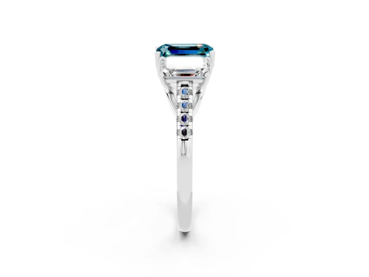 Three-Stone Emerald Cut Blue Topaz Ring with Round Pavé Band and Prong Setting Platinum