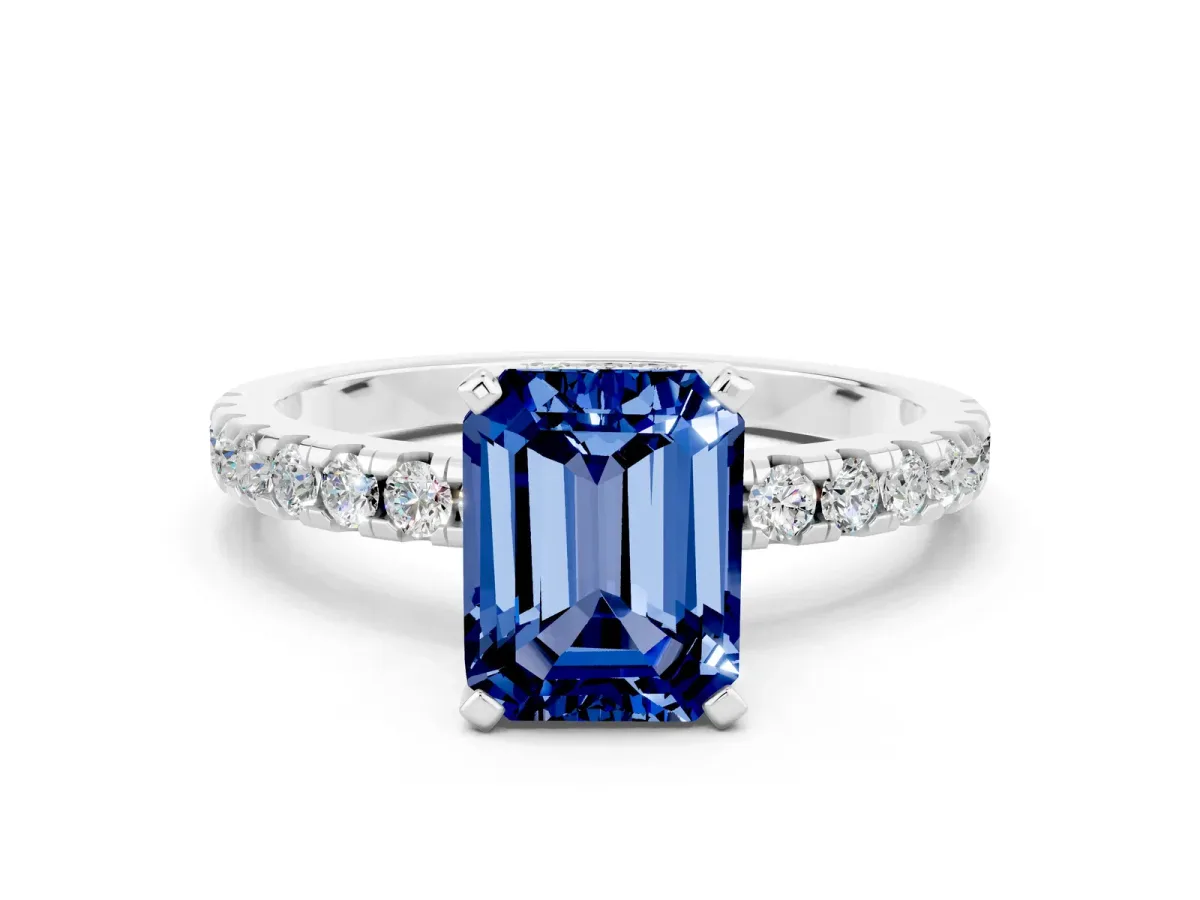 Emerald Cut Blue Sapphire Solitaire Ring with Round Pavé Band and Four-Prong Setting Silver