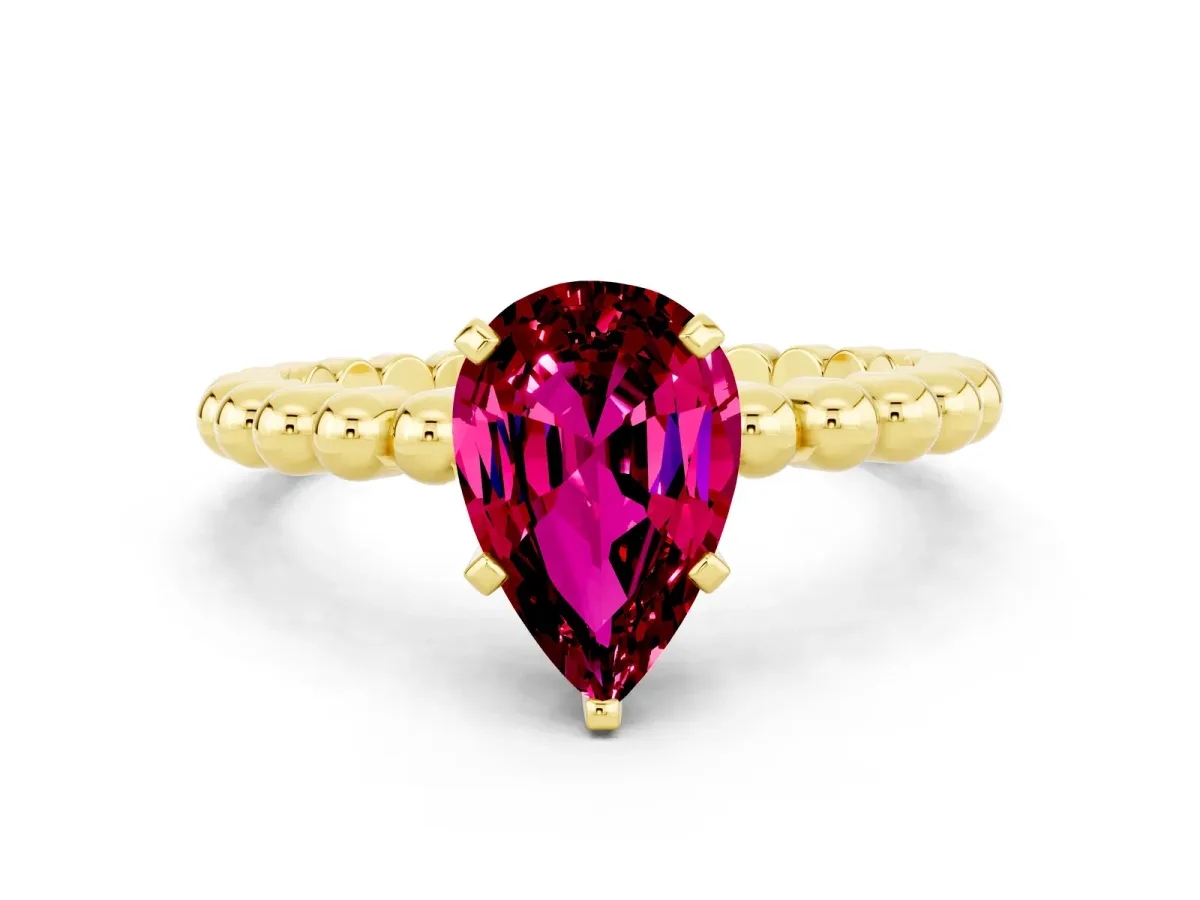 Pear Cut Garnet Solitaire Ring with Beaded Band and Prong Setting Yellow gold