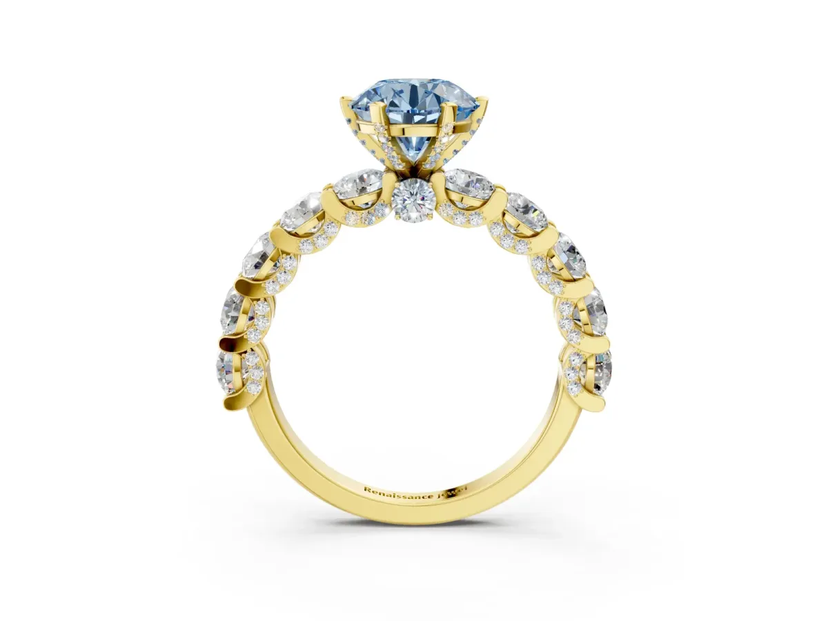 Fancy Blue Round Cut Diamond Side Stone Engagement Ring with Four-Prong Setting Yellow gold