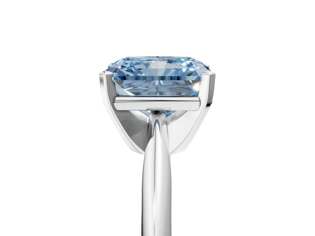 Fancy Blue Radiant Cut Cut Solitaire Ring with Four-Prong Setting on a Classic Band Platinum