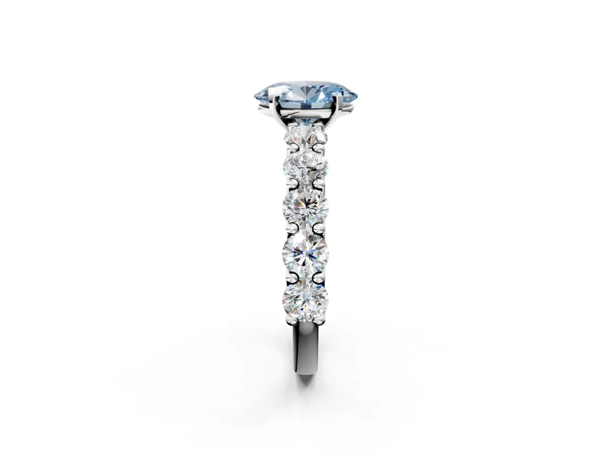 Fancy Blue Oval Cut Diamond Prong Setting with Side Stones on a Pave Band Platinum
