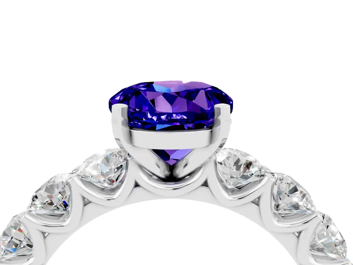 Round Cut Tanzanite Prong Setting with Side Stones on a Pave Band Silver