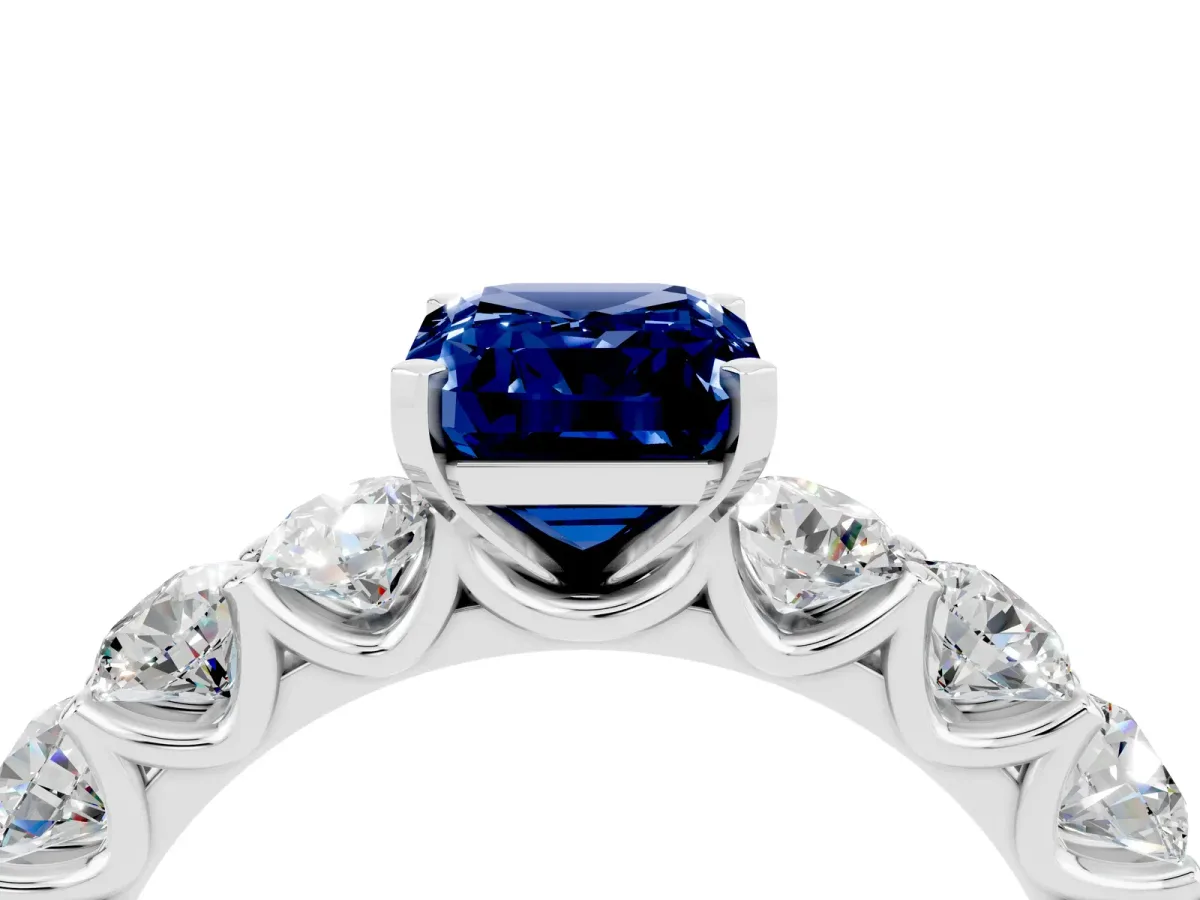 Emerald Cut Blue Sapphire Prong Setting with Side Stones on a Pave Band Silver