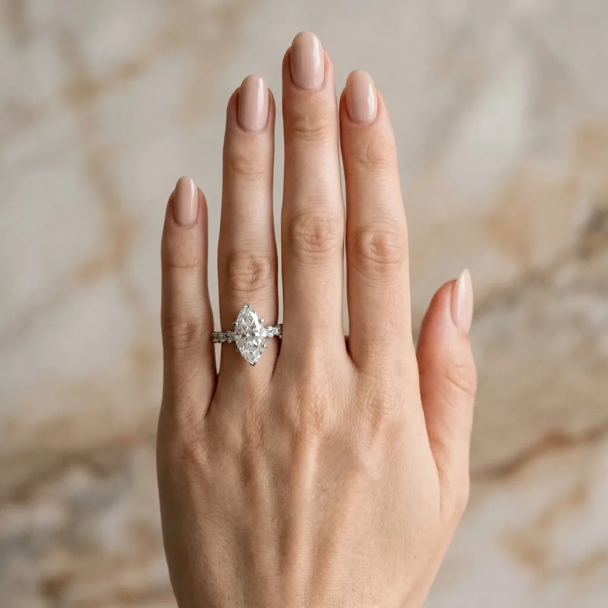 Marquise Cut Diamond Side Stone Solitaire Ring with Round and Four-Prong Setting Platinum