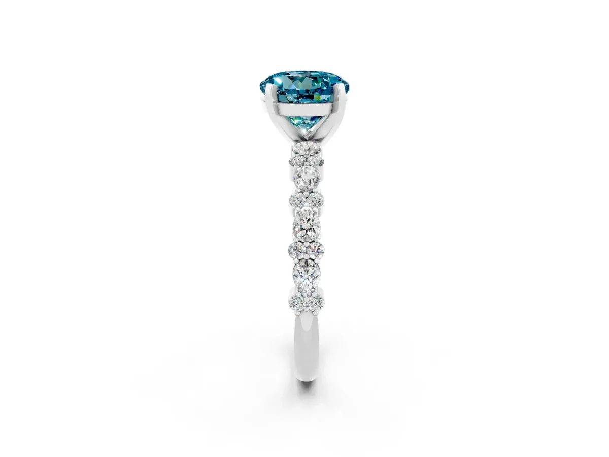Round Cut Blue Topaz Side Stone Solitaire Ring with Round and Four-Prong Setting Silver