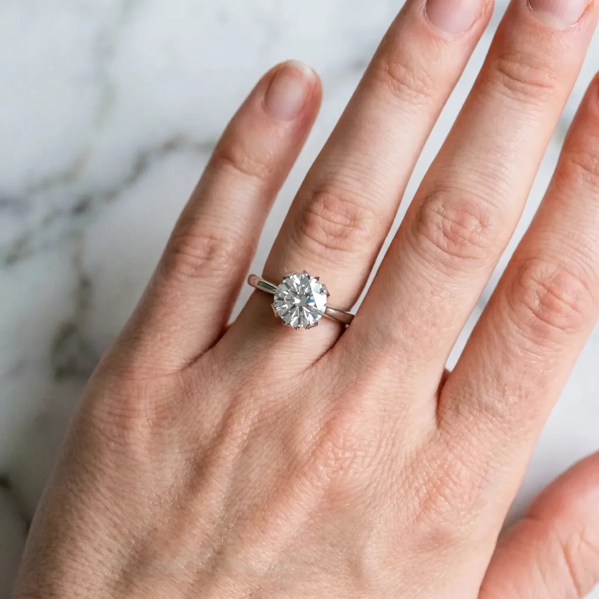 Round Cut Diamond Solitaire Ring with Flower Prong Setting and Classic Band Silver