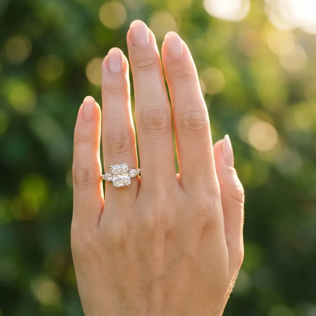 Three-Stone Radiant Cut Diamond Ring with Pear Side Stones in Four-Prong Setting Platinum
