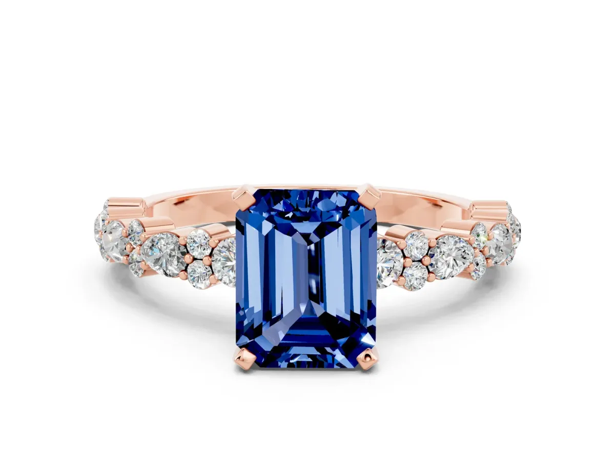 Emerald Cut Blue Sapphire Side Stone Solitaire Ring with Round and Four-Prong Setting Rose gold
