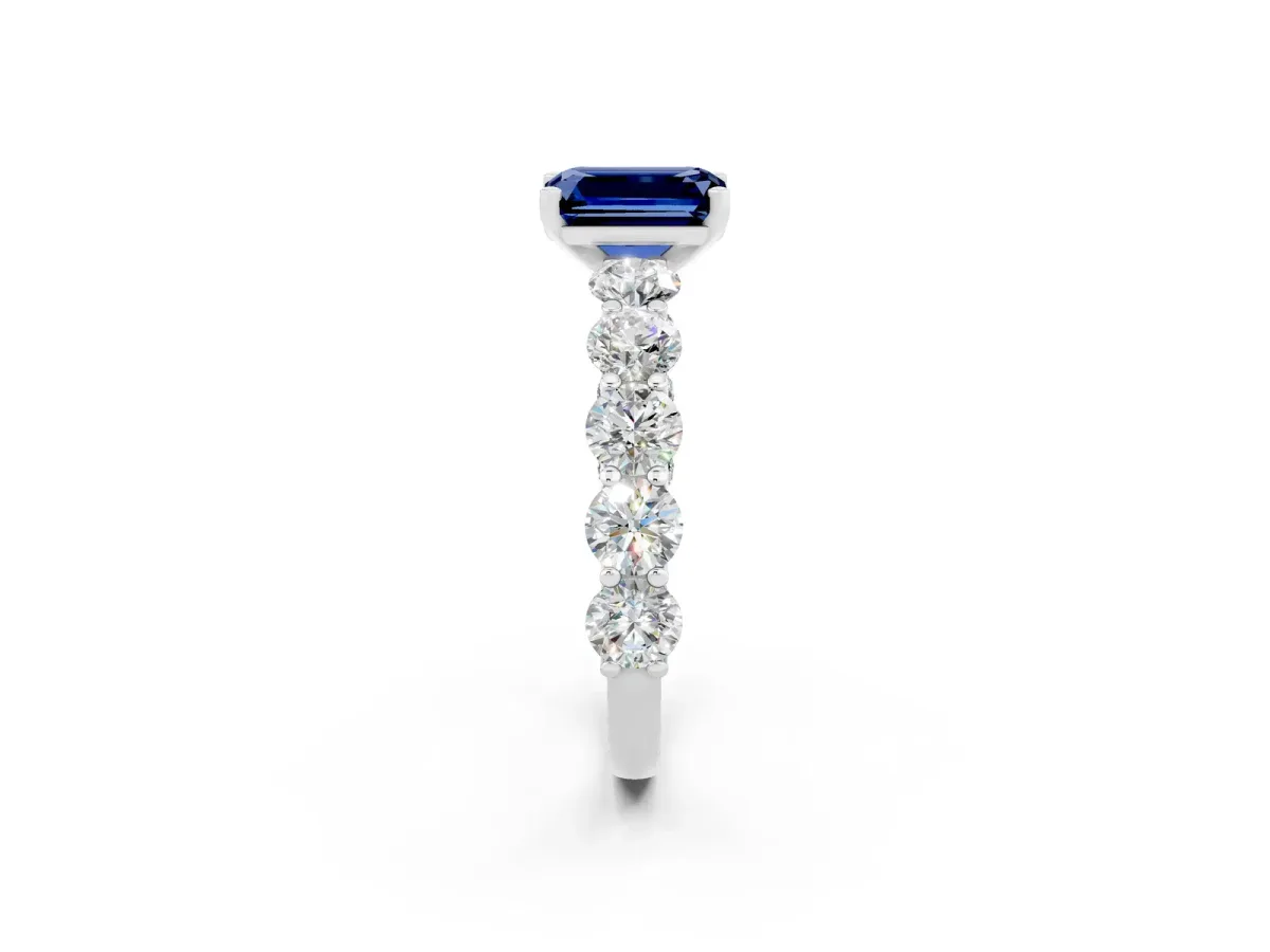 Emerald Cut Blue Sapphire Prong Setting with Side Stones on a Pave Band Silver