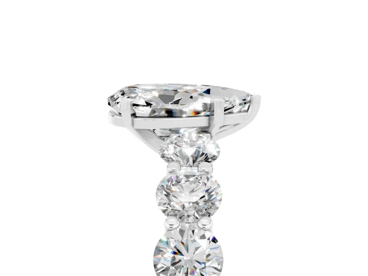 Pear Cut Moissanite Prong Setting with Side Stones on a Pave Band Silver