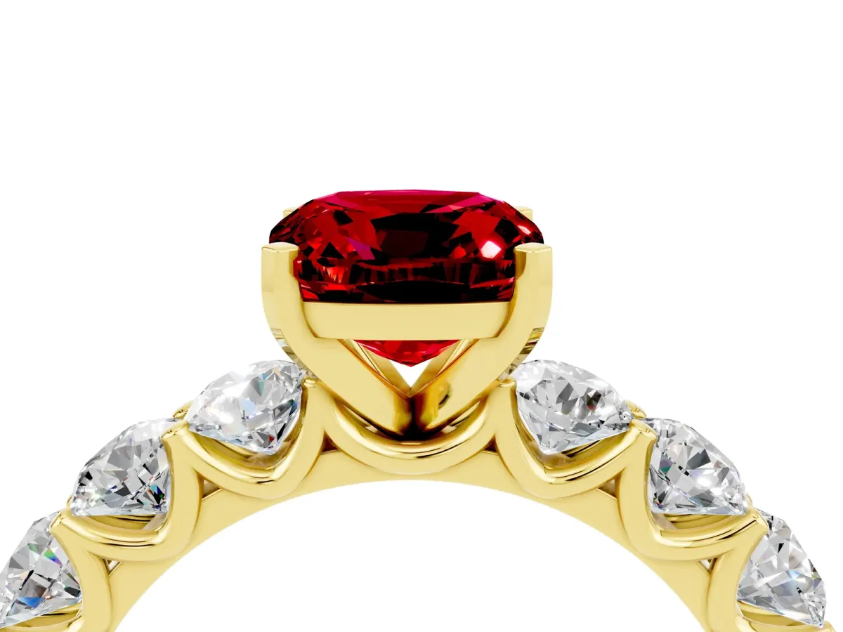 Cushion Cut Ruby Prong Setting with Side Stones on a Pave Band Yellow gold