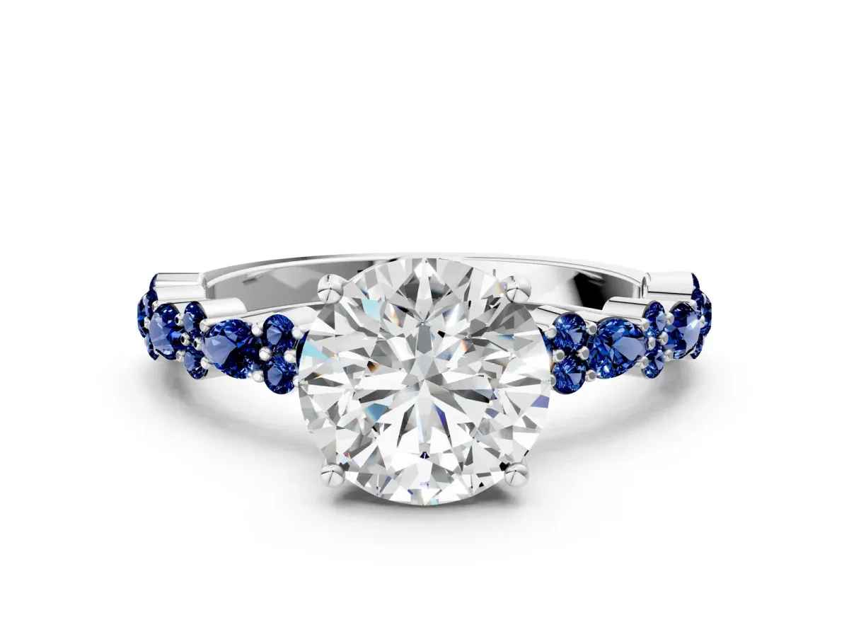 Round Cut Diamond Side Stone Solitaire Ring with Round Blue Sapphire and Four-Prong Setting Platinum