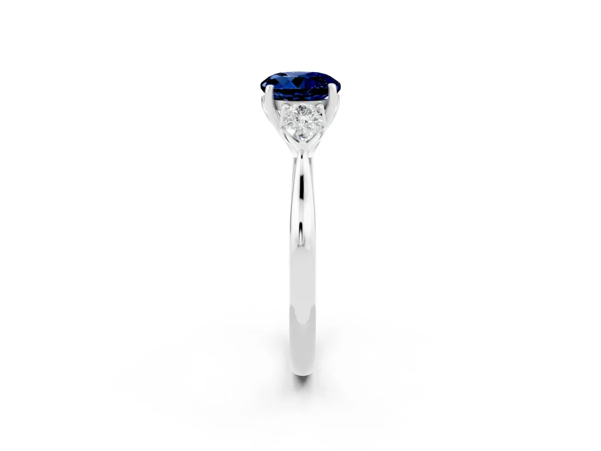 Three-Stone Round Cut Blue Sapphire Ring with Pear Side Stones in Four-Prong Setting Platinum