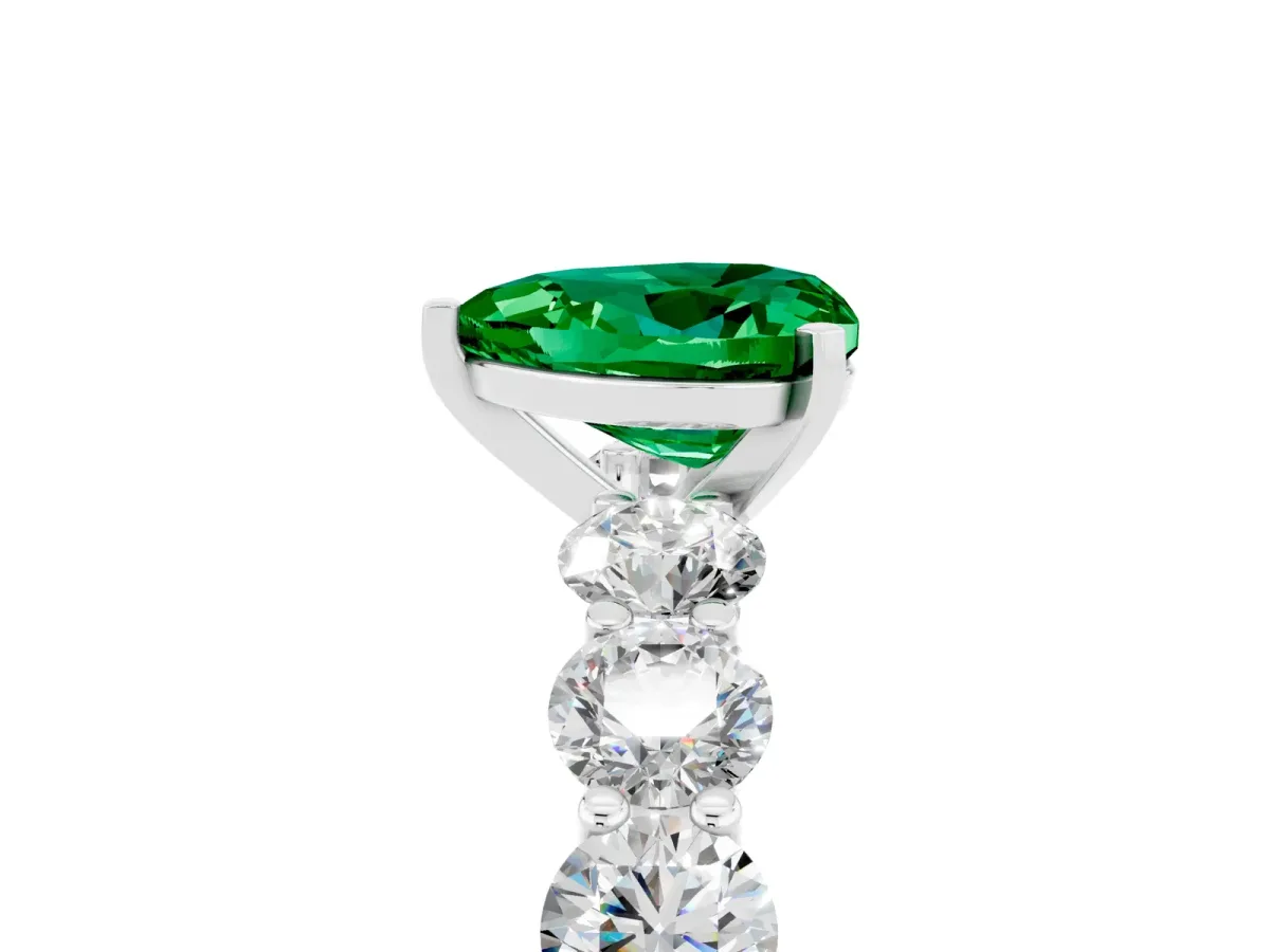 Heart Cut Emerald Prong Setting with Side Stones on a Pave Band Platinum