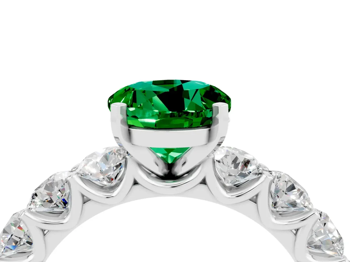 Round Cut Emerald Prong Setting with Side Stones on a Pave Band Silver