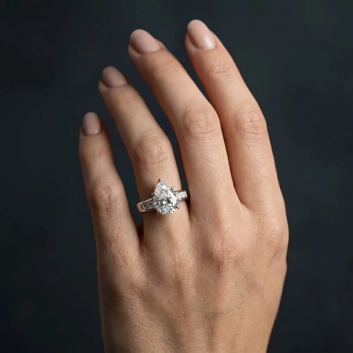 Pear Cut Cut Channel Set Solitaire Ring with Four-Prong Setting Platinum
