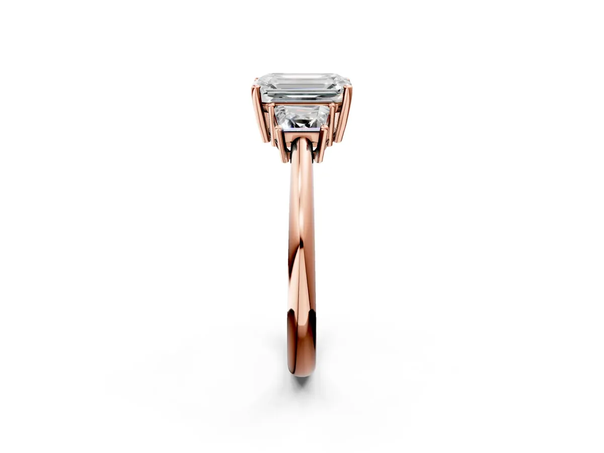 Emerald Cut Diamond Three-Stone Ring with Trapezoid Side Stones and Prong Setting Rose gold