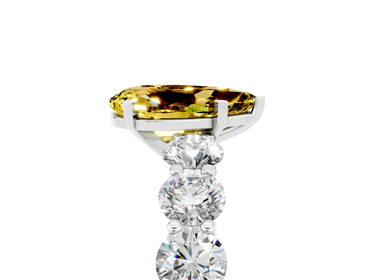 Pear Cut Yellow Sapphire Prong Setting with Side Stones on a Pave Band Silver