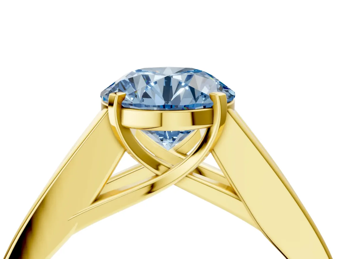 Fancy Blue Round Cut Cut Channel Set Solitaire Ring with Four-Prong Setting Yellow gold